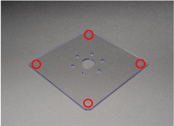 A cover part for a machine made of transpiration resin (PET) with tapped holes.